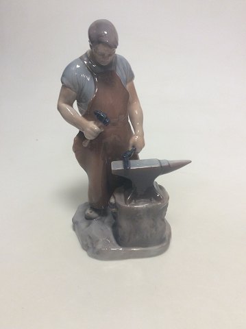 Royal Copenhagen figurine of a blacksmith no 460. Old Bing and Grondahl number is 2225