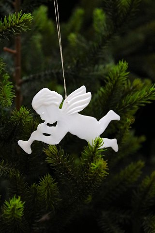 Old Christmas tree ornament in the shape of a little angel playing a trumpet in 
white plastic from the 50s...