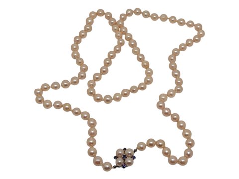 Long Akoya pearl necklace with 14 carat white gold pendant with blue sapphires
