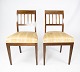 A pair of dining room chairs of mahogany with inlaid wood upholstered with light fabric from the 1920s.5000m2 showroom.