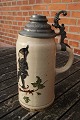 Large pitcher in faience with tin lid, decorated with a pixie