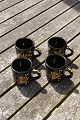 Swedish ceramics, set of 4 small mugs 6cm with 
black glaze and with decoration.