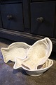Old cream-colored earthenware bowl in the shape of a fish...
