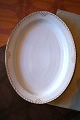 Rare oval Royal Copenhagen serving dish in Princess with gold decorations. 
41x32.5cm...