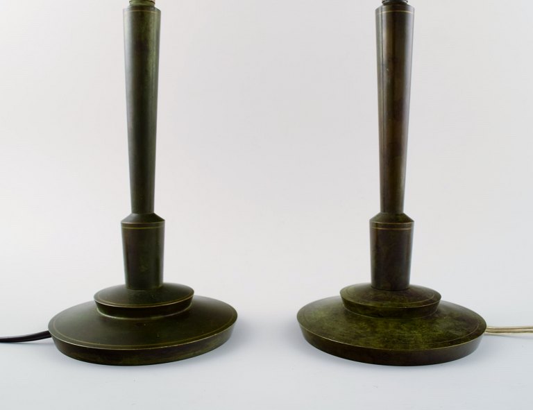 Just Andersen style. A pair of table lamps of bronze on a circular foot, socket in bakelite.