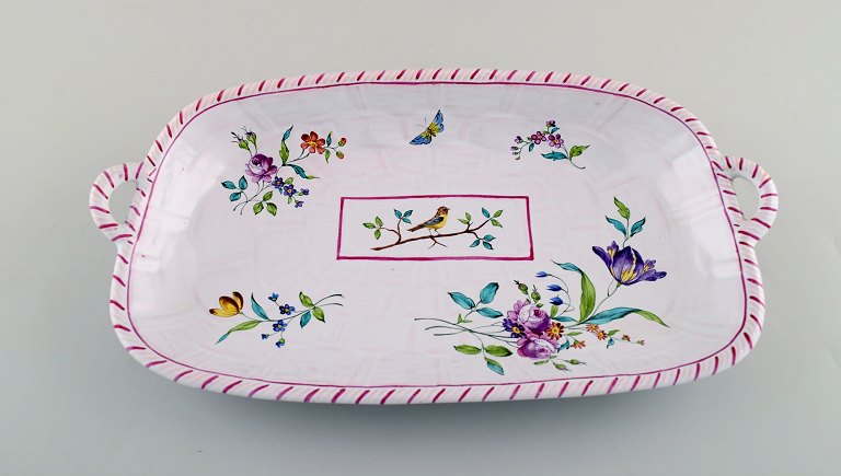 Emile Gallé for St. Clement, Nancy. Dish on four feet in hand-painted faience. Decorated with flowers and birds. 1870