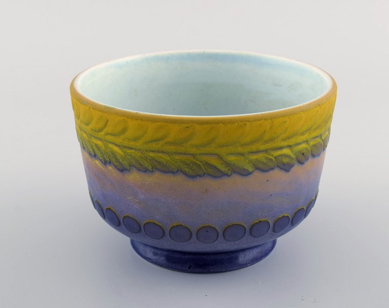 Gunnar Wennerberg for Gustavsberg. Antique unique bowl in glazed ceramics. Beautiful glaze in yellow and purple shades. Leaves and dots in relief. Dated 1906.