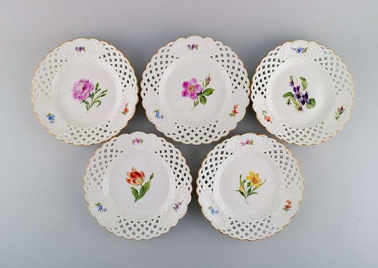 Fem antikke Meissen tallerkener i gennembrudt porcelæn med håndmalede blomster og guldkant. Tidligt 1900-tallet.