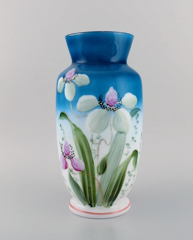 Antique vase in mouth-blown opal art glass with hand-painted flowers and foliage on a blue background. Approx. 1900.