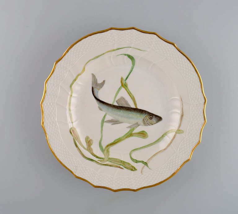 Royal Copenhagen porcelain dinner plate with hand-painted fish motif and golden border. Flora / Fauna Danica style. Dated 1968.