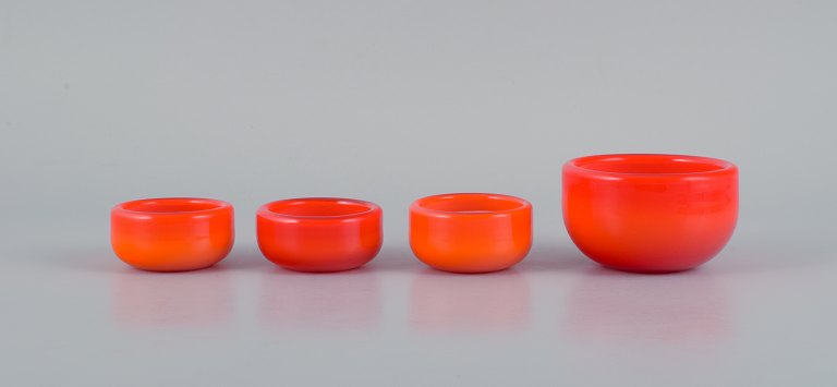 Michael Bang for Holmegaard.Four glass bowls in orange and white art glass.