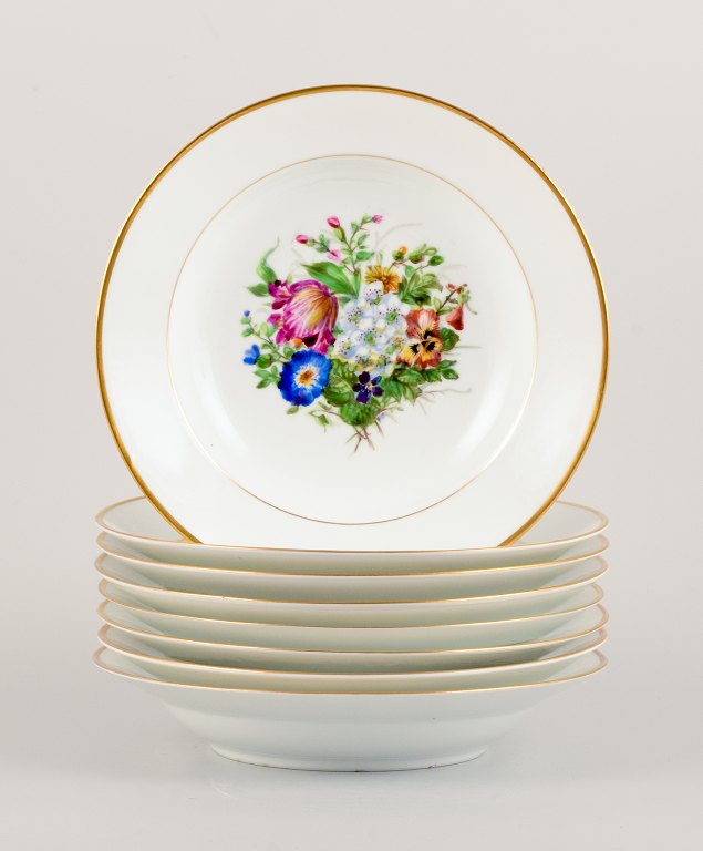 Bing & Grøndahl, eight deep plates in porcelain hand-painted with polychrome flowers and gold decoration.