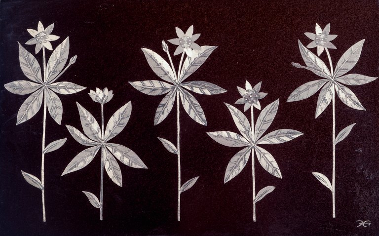 Heinz Erret (1920-2003) for Gustavsberg. "Skogsstjärna" wall plaque in glazed ceramic with silver inlay in the form of flowers.