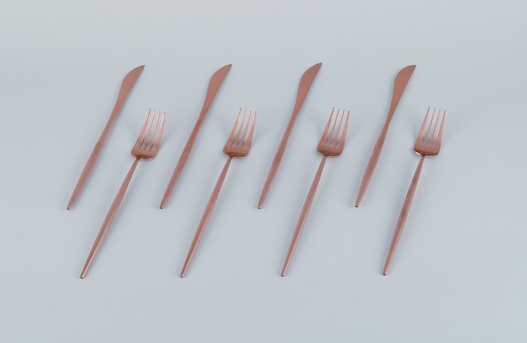 A set of four-person modernist dinner flatware in brass, consisting of four dinner knives and four dinner forks.