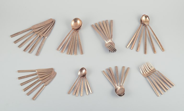 Scandinavian designer. Large and complete six-person dinner service in handcrafted hammered brass. High-quality craftsmanship.