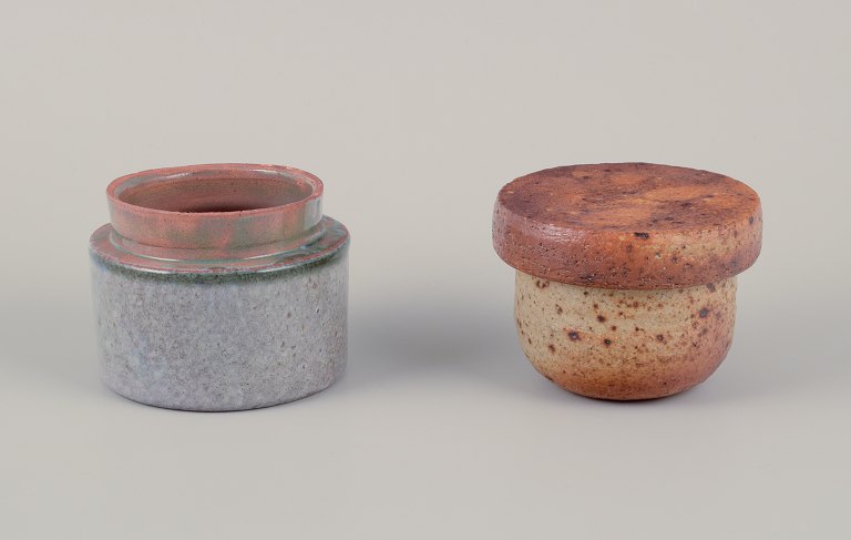 European studio potter. Two unique ceramic jars, one with a lid. Glazed in earth tones and blue-gray hues.
