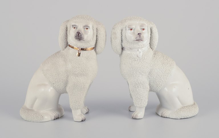 Et par antikke engelske Staffordshire krymmelhunde i porcelæn.